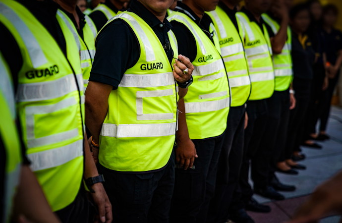 Asian Securities and Guards are stadning in the row meeting and waiting for order from commander in Thailand Concert Event.