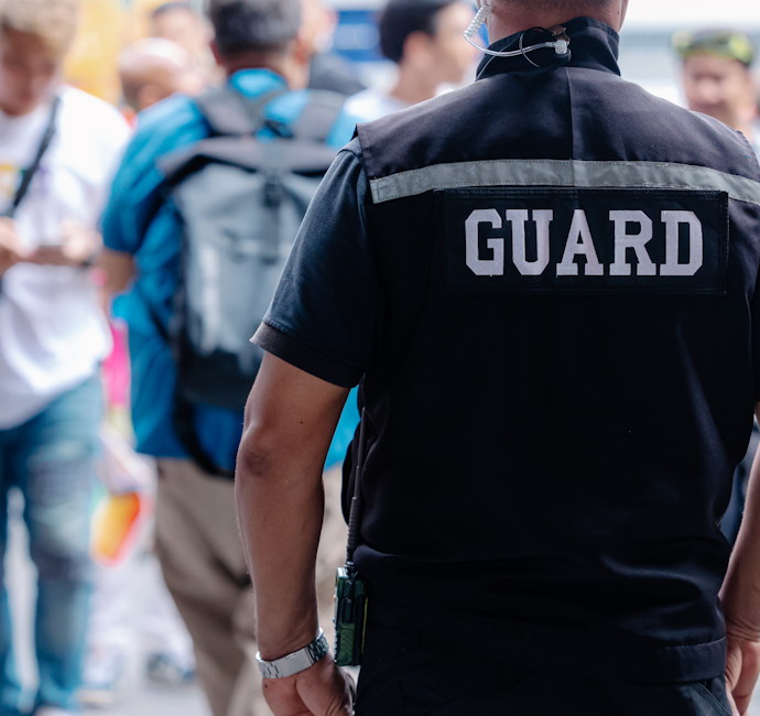 closeup security guard man in public area standing secure people or place outdoor.